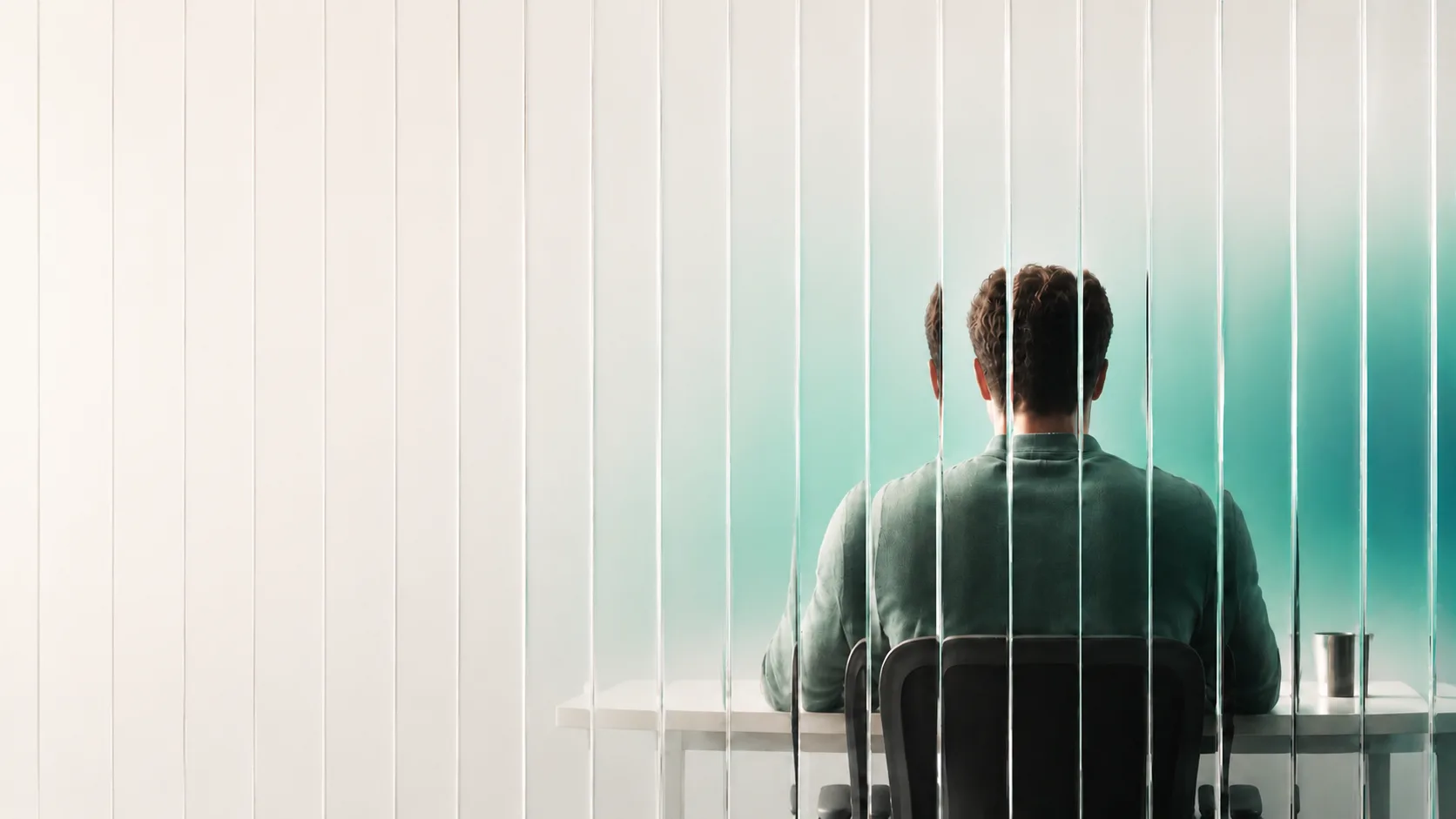 Person working at a workspace behind fluted glass panes in light theme